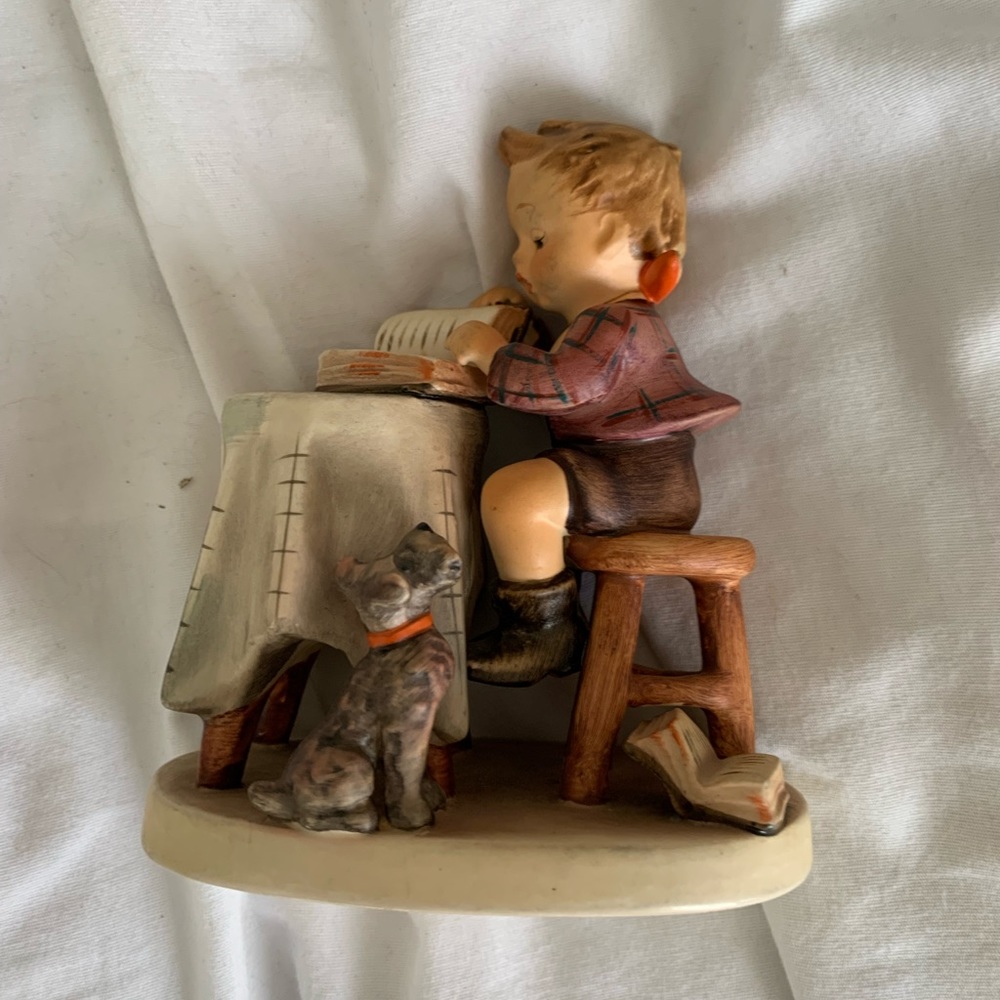 Little boy reading with dog Hummel - west Germany